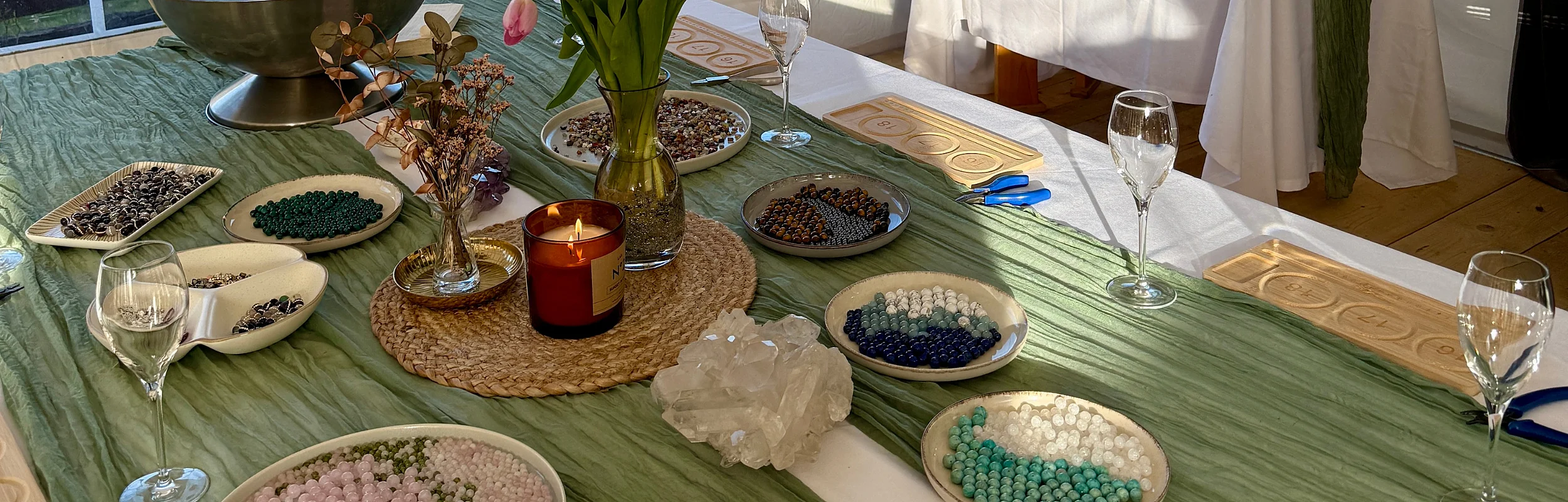 Schön dekorierter Tisch mit Blumen, Perlen und Prosecco